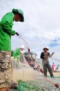 Fishermen are removing anchovies fish from their nets to start a new working day in Ly Son island Royalty Free Stock Photo