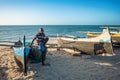 Fishermen resting on sailboats, traditional outrigger canoe in the coast of Anakao in Madagascar