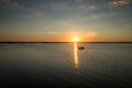 Fishermen are returning from fishing on Lake Lebsko at sunset. Cloudless sky, summer, light is reflected in the water. Royalty Free Stock Photo