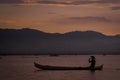 Fishermen returning from looking for sustenance at Limboto Lake with a sunset view Royalty Free Stock Photo