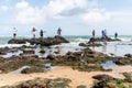 fishermen on the rocks catching fish with their fishing poles on the beach of Rio Vermelho Royalty Free Stock Photo