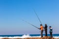 Fishermen Rods Rocks Blue Sea
