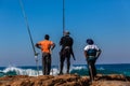 Fishermen Rods Rocks Blue Sea