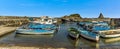 Fishermen`s boats in the harbour at Aci Trezza, Sicily against a background of Isole dei Ciclopi