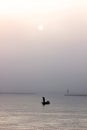 Fishermen`s in countryside lifestyle using nets to catch fish at the lake in the morning with foggy days, Fisherman on boat using Royalty Free Stock Photo