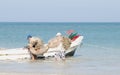 Fishermen sail with nets from the beach