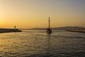 Fishermen and sailboat at sunset in Alimos marina in Athens, Greece Royalty Free Stock Photo