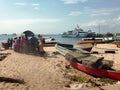 Fishermen on a sandy beach prepare their wooden boat boat for swimming and fishing Royalty Free Stock Photo