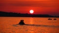 Fishermen on sea at red sunset Royalty Free Stock Photo