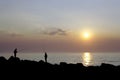 Fishermen by the sea at sunset Royalty Free Stock Photo