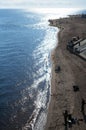 Fishermen on the shore of the bay with sunny backlighting