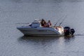 Fishermen sit in a motorboat. Convenient motor boat for fishing. Wait for the fish.