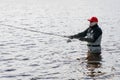 Fishermen spin fishing using chest waders Royalty Free Stock Photo