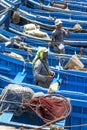 Fishermen stand amongst a sea of boats in the harbour in Essaouira in Morocco.