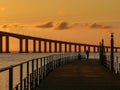 Fishermen at sunrise near Vasco da Gama Bridge, the longest bridge in Europe, who spans the Tagus River, in Lisbon, Portugal Royalty Free Stock Photo