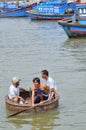 Fishermen are swimming from their vessels to the seaport in a basket boat