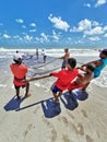 Fishermen taking net and fish from the sea at Lucena beach, ParaÃÂ­ba, Brazil Royalty Free Stock Photo