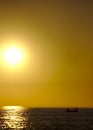 Fishermen on their boat during sunset