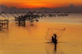 Fishermen throwing fishing net from his boat early morning Royalty Free Stock Photo