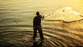 A fishermen throwing fishing net during sunrise in Al Khobar seaside Saudi Arabia Royalty Free Stock Photo