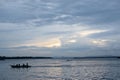 Fishermen on tiny fishing boat on the sea before sunrise Royalty Free Stock Photo