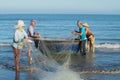 Fishermen untangle a network, ready to go to sea for fishing. Vietnam