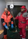 Fishermen weighing catch Royalty Free Stock Photo