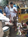 Fishermen weighing fish for sale . Fish market . Festival season . Royalty Free Stock Photo