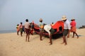 Fishermen work hard to bring the fishing boat to the shore