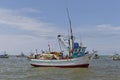 Fishermen working on the deck of an anchored Peruvian Inshore Fishing Boat