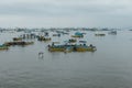 Fishermen working in the fishing fleet near the pier in the city of Manta on a cloudy day