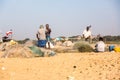 Fishermen working on sand beach