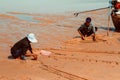 Fishermen works hard to catch clams