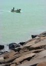 Fishermen at works on the wooden motor boat.