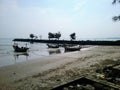 Fishermen& x27;s boats are docked against the backdrop of the wave-breaking pier in Kradenan Palang, Tuban, East Java.