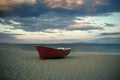 Fishermens boat at seacoast, on sand at sunset with horisont sea on background. Travel and rest concept. Background of Royalty Free Stock Photo