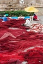 Fishermens mend their fishing nets in the port of Essaouira, Morocco