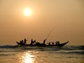 Fishers on boat in sunset on the sea Royalty Free Stock Photo