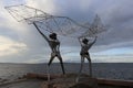 Fishermen throw net in the sea Royalty Free Stock Photo