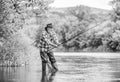 Fishers have long rods. retired bearded fisher. Trout bait. fisherman with fishing rod. mature man fly fishing. man Royalty Free Stock Photo