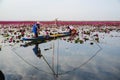 Fisherwoman on blue boat fishing by using fishing traditional fishing net