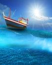 Fishery boat floating on blue sea wave with sun shining on blue sky