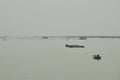 Fishery boat floating on the dull sea