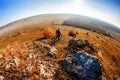 Fisheye of cyclist standing with mountain bike at sunrise against bright sun and blue sky. Royalty Free Stock Photo