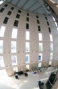 Fisheye shot of atrium of office with tall pillars and a huge open space