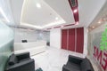 Fisheye shot of modern office with white walls and red inserts