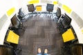 Fisheye shot of office with grey carpet and yellow and black chairs