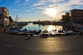 Fisheye view of boats, blue sky and sun reflection at Piran harbor, Istria