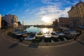 Fisheye view of boats, blue sky and sun reflection at Piran harbor, Istria