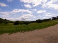 Fisheye view of people having a rest on a meadow on background of cloudy sky Royalty Free Stock Photo